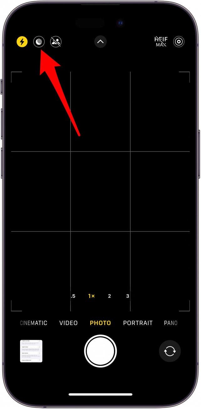 iphone camera app with red arrow pointing to night mode icon in upper left corner