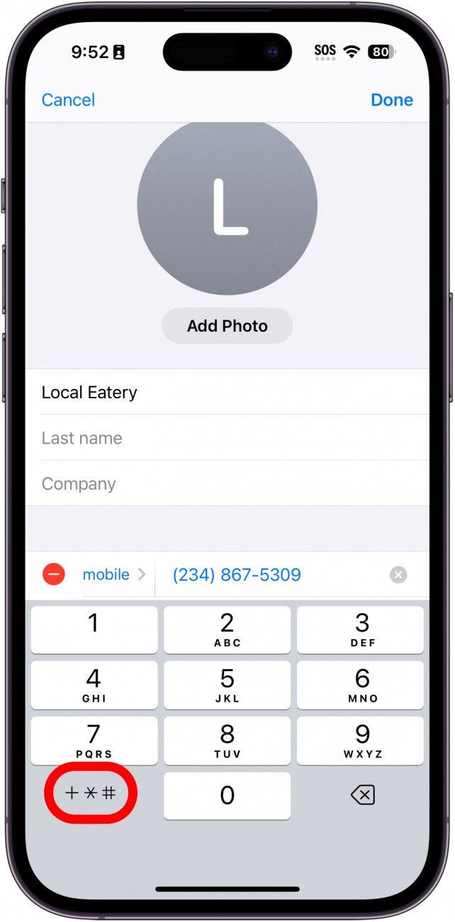 iphone edit contact phone number screen displaying a keypad and a red box around the extra symbols button