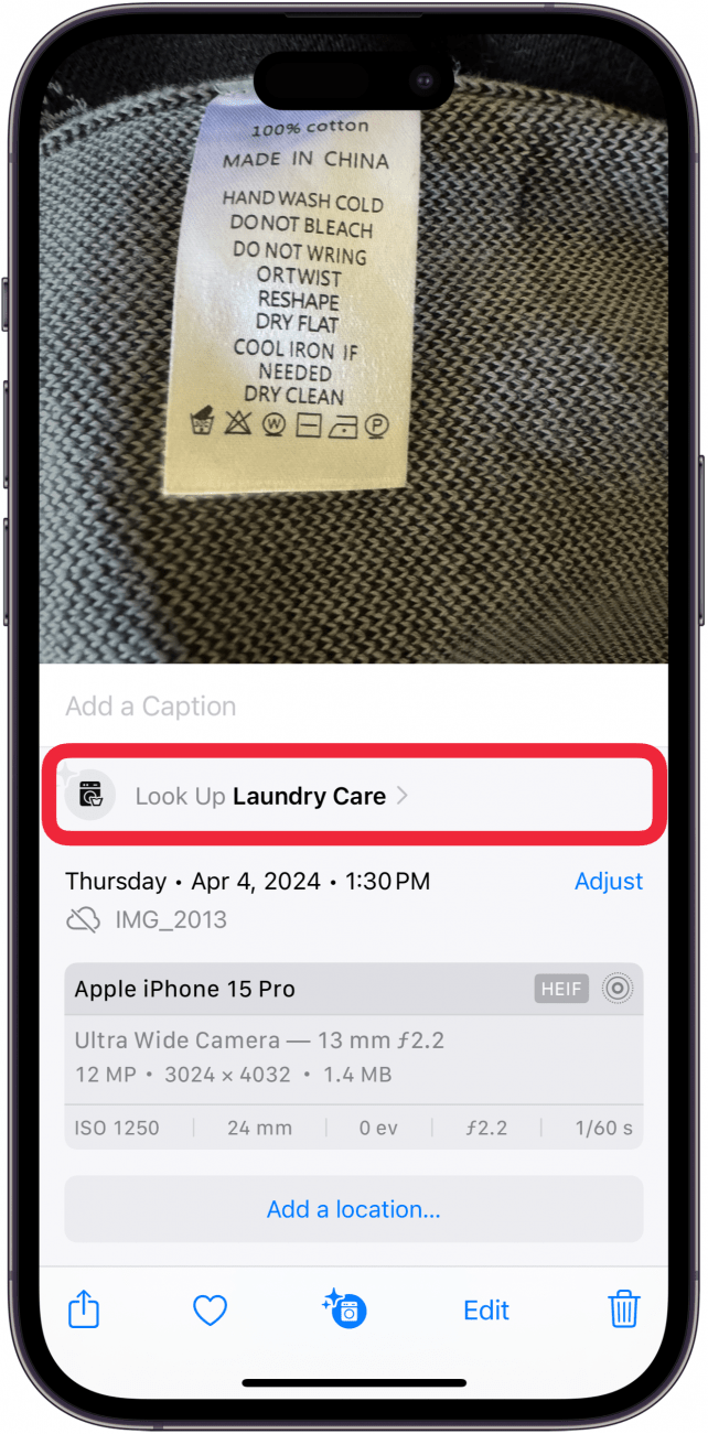 iphone photos app displaying a photo a laundry tag on a sweater, with the info menu open, and a red box around "look up laundry care" button