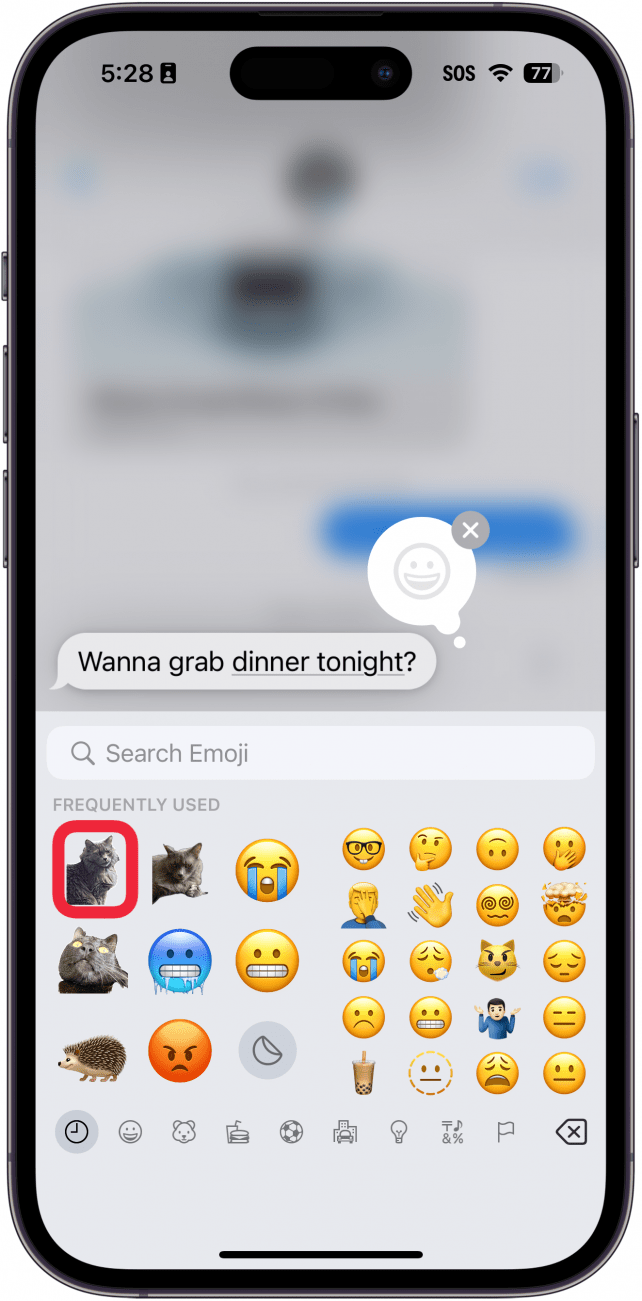 iphone messages app tapback menu displaying emojis keyboard with a red box around a cat sticker