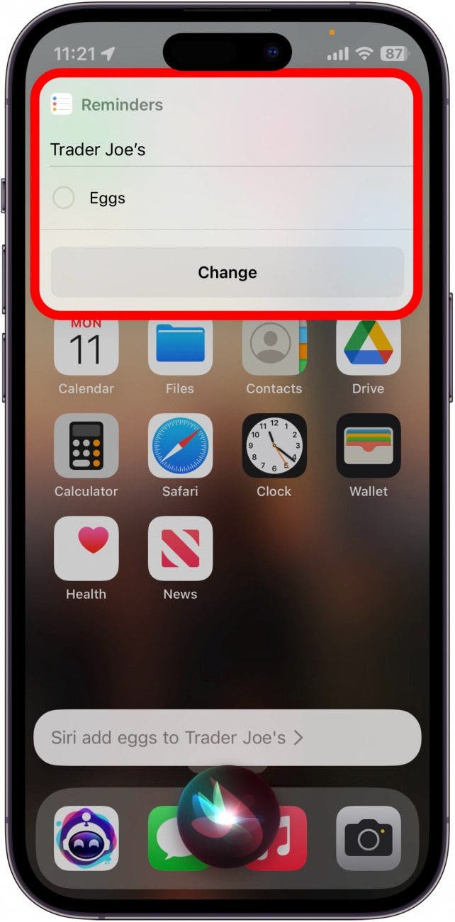 iphone home screen with siri speech bubble with a red circle around a window displaying a remidners list titled, "trader joe's" and an item, "eggs," has been added. There is also a button labeled change, indicating that the user can edit information about the new item that has been added to the list