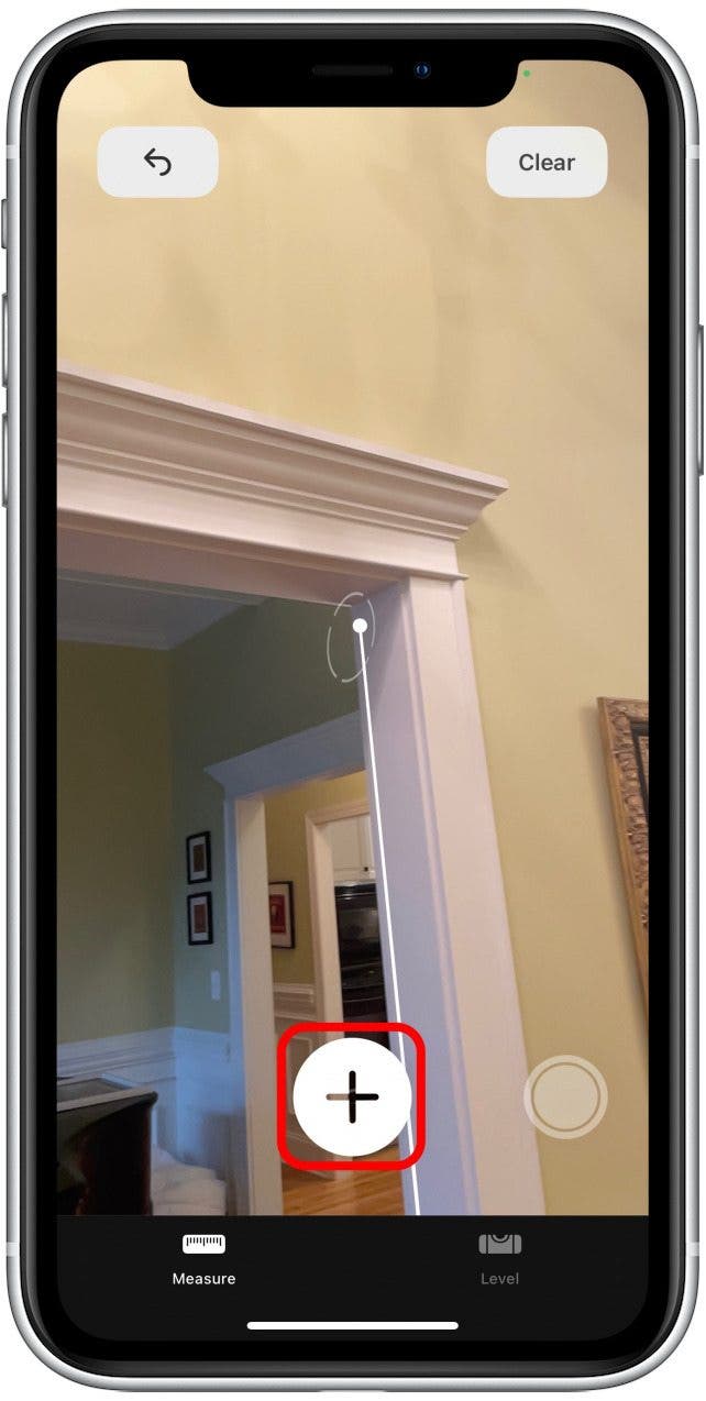 Move your device to the point where you want to stop measuring, and tap the plus sign again. You'll see a dotted line as you move your iPhone or iPad.