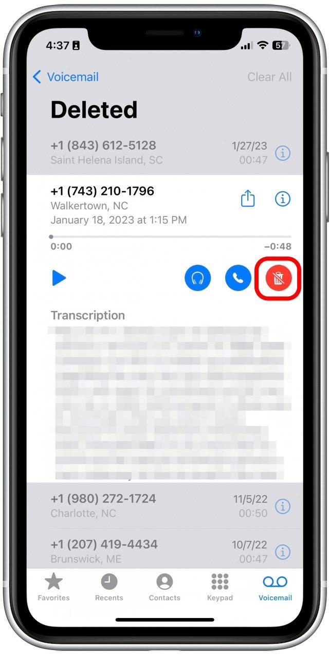 Tap the red trashcan with a slash through it. The message will automatically be moved back into your main Voicemail box.