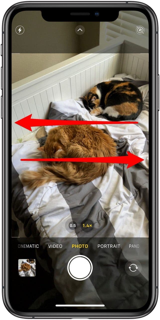 Camera app in Photo mode with two arrows marked on the screen, one pointing from the right side to the left, the other from the left side to the right.