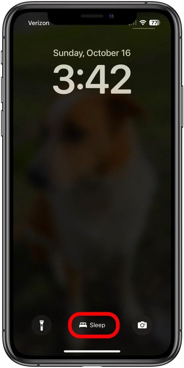 Lock Screen while the iPhone is in Sleep Focus and the name of the mode, Sleep, is marked at the bottom of the screen.